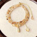 Women's gold natural citrine bracelet with three layered circles and Saturn design details.