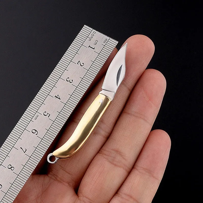 Brass mini folding knife keychain pendant with 3cm blade and 42mm shank on a key ring