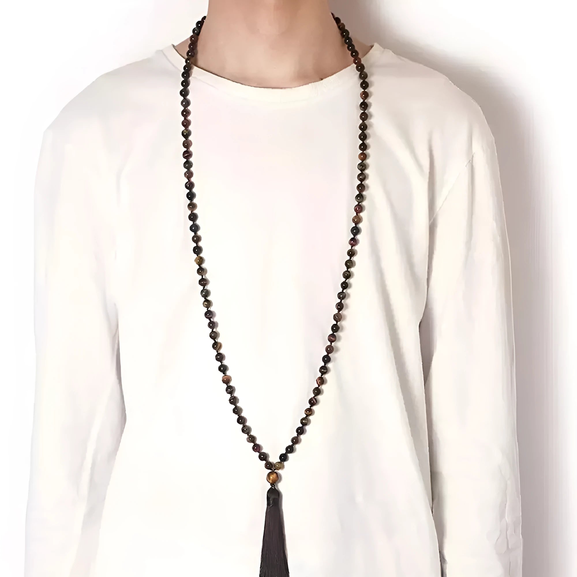 Long blue gemstone tassel necklace with agate, lapis lazuli, and turquoise beads on a geometric pendant.