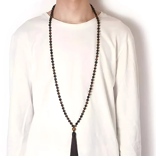 Long blue gemstone tassel necklace with agate, lapis lazuli, and turquoise beads on a geometric pendant.