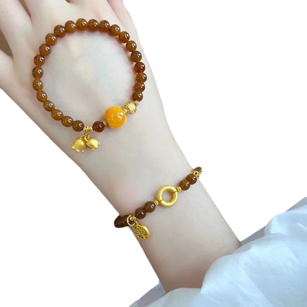 Women's caramel beeswax Lily bracelet with flower-shaped natural stone charm and electroplated finish.
