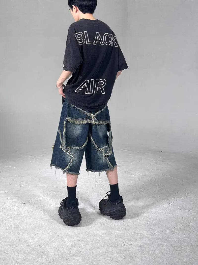 Blue retro-style men's denim shorts with a frayed five-pointed star design and a loose fit.