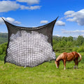 Black woven grid horse feeding bag hanging, showing its open structure and size.