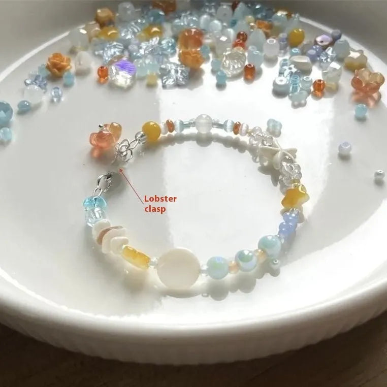 Orange women's bracelet with diamond links and round decorative elements on wrist