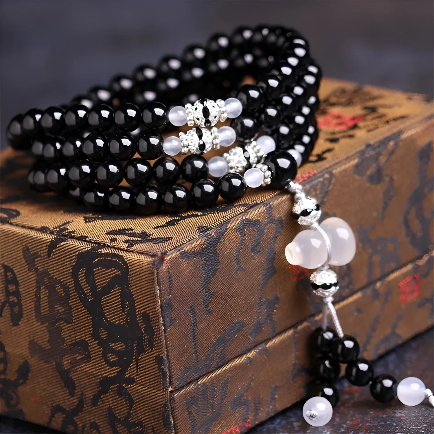 Black agate 108 bead unisex geometric bracelet with number elements.