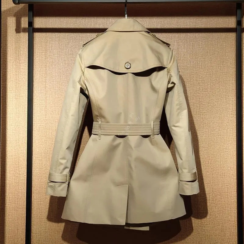 Women's khaki trench coat with double-breasted front and flight sleeves on hanger