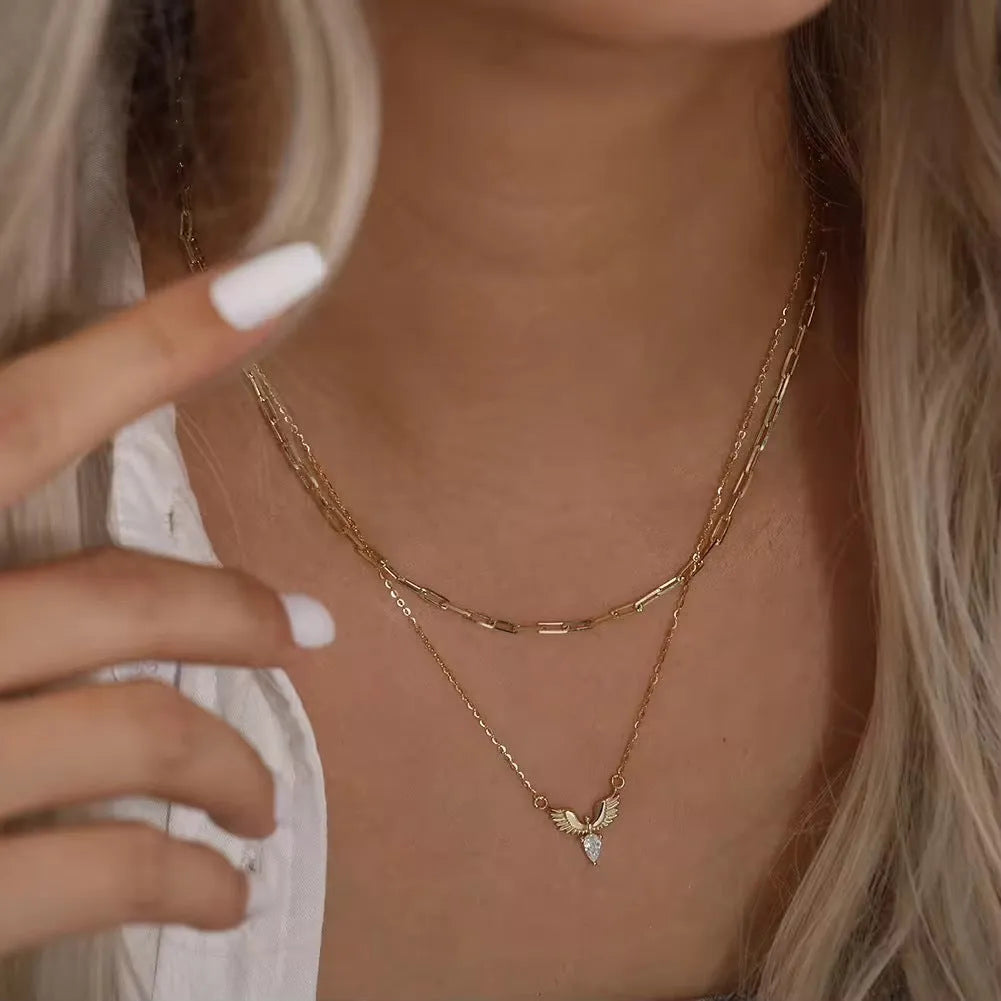 A silver necklace with an eagle pendant on an adjustable O-ring chain, available in white gold or yellow gold colour finish.