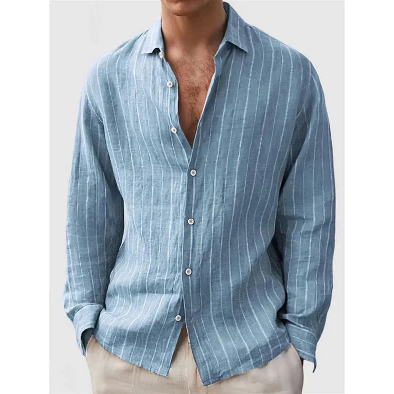 Man wearing a loose fit, short sleeve, striped cardigan shirt in a casual setting.
