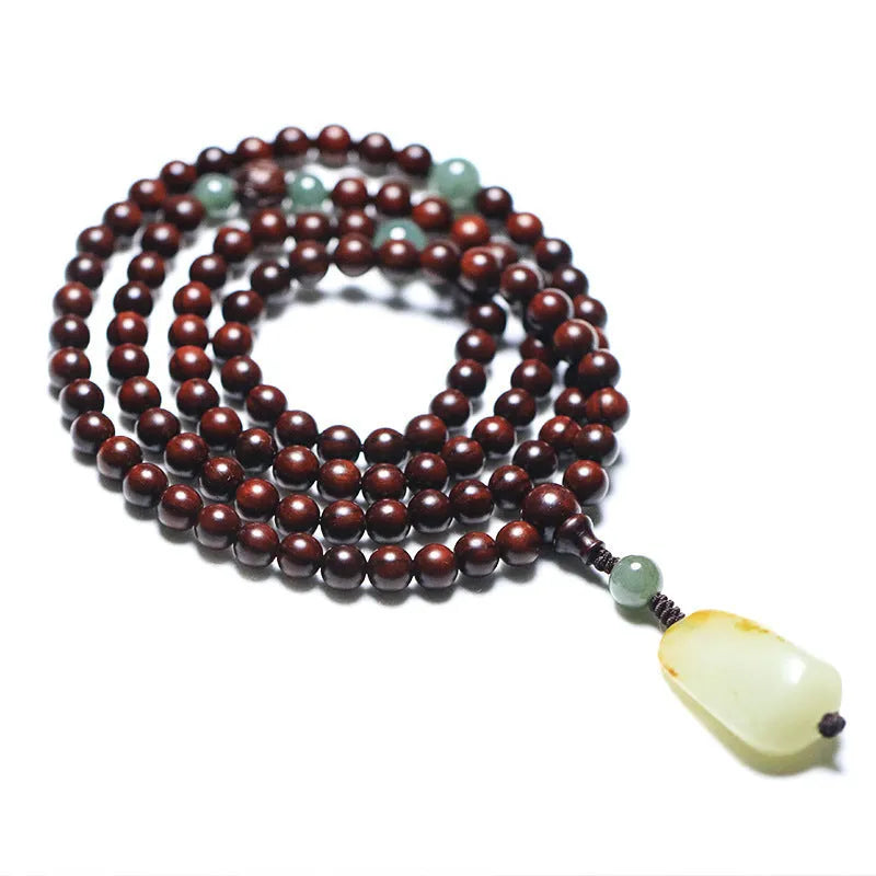 Rosewood beaded bracelet with carved wood elements and green Hotian jade pendant on wrist