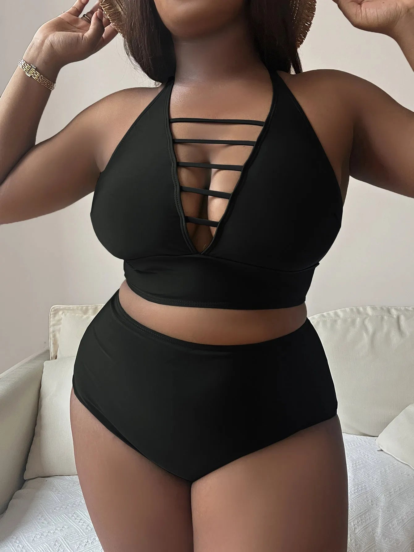 Plus size woman in a solid colour halter neck bikini with adjustable cross-back straps and high-waisted briefs.