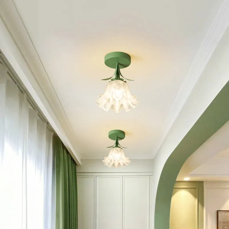 Cream coloured Linglan flower modern corridor wall light fixture on display.