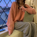 A woman's loose-fitting solid colour pullover sweater in a retro style, shown in a choice of colours.