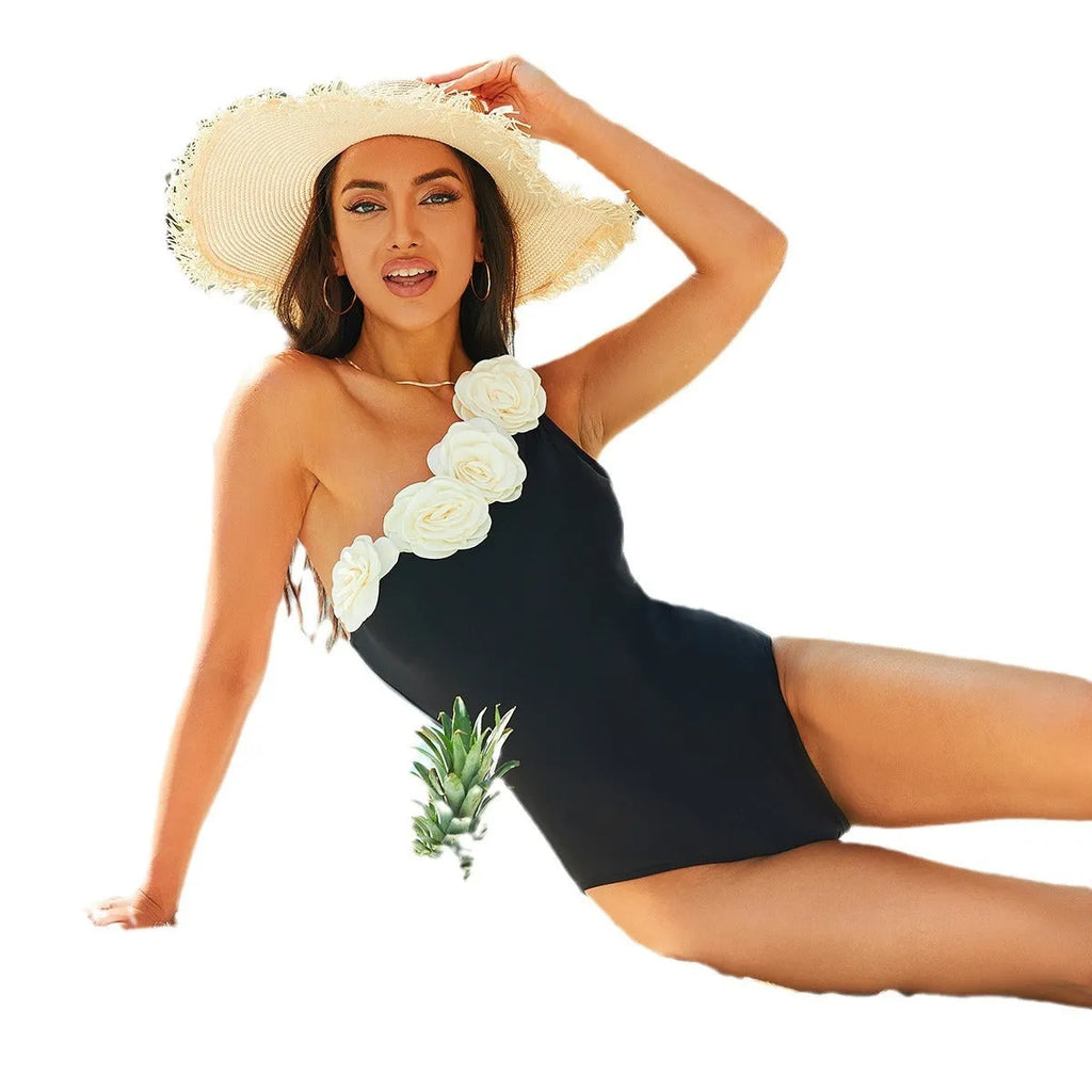 Black floral one-piece swimsuit for women shown on a mannequin