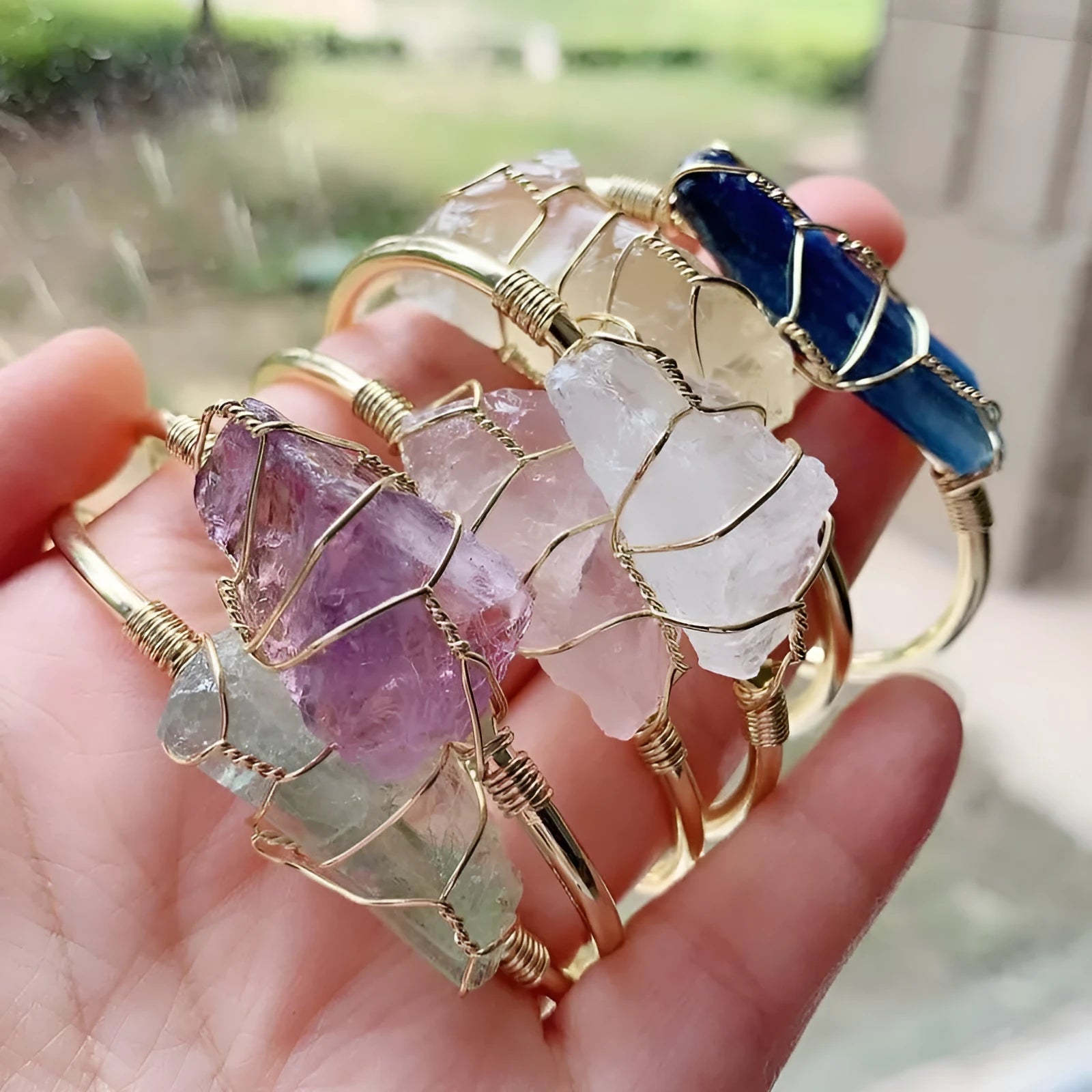 Natural crystal rough stone bracelet with gold winding geometric design showing colour mixing finish