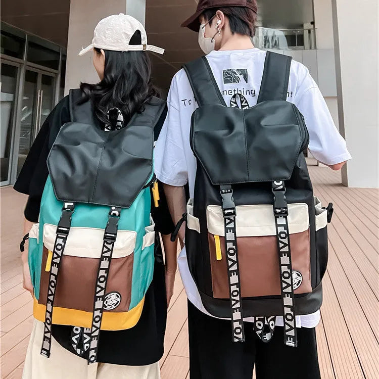 Oxford cloth student backpack in black, green, or red, showing handheld and shoulder straps.