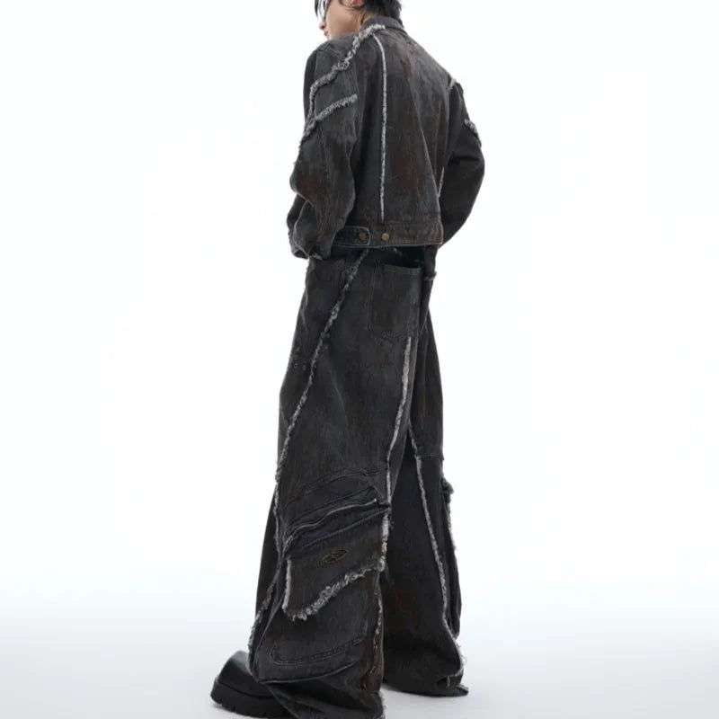 Black denim coat and trouser set with distressed raw edges and a splash-dye gradient pattern.