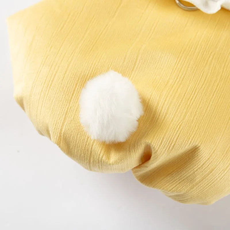 Bunny embroidered pet coat with ruffled white collar and fluffy pom-pom tail in lavender colour on a small dog