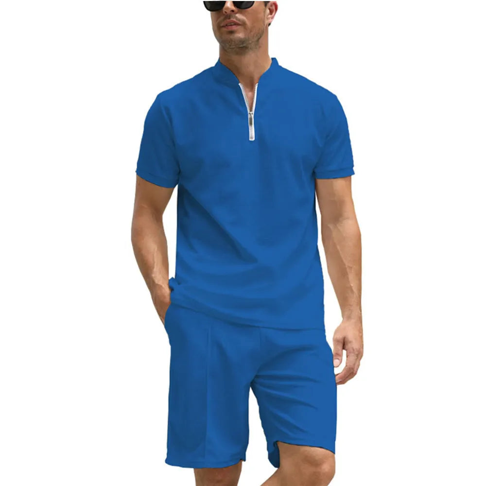 Men's solid colour polo shirt and matching trousers two-piece set in textured fabric.