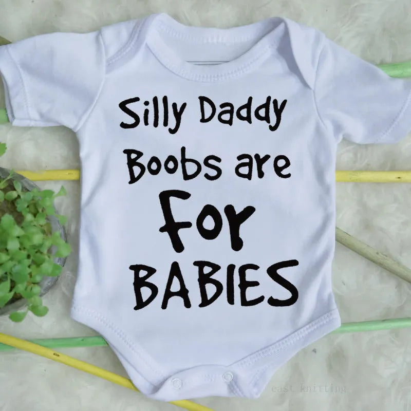 White triangle climbing baby bodysuit with black text reading 'Silly Daddy Boobs Are For Babies'
