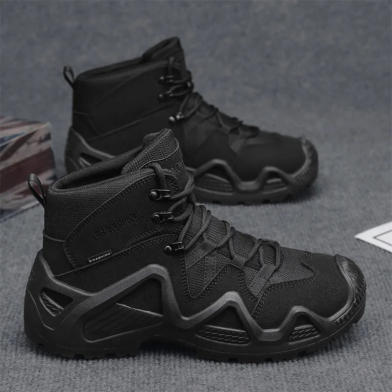Black canvas high-top tactical boot with rubber sole and cross strap detail on a white background.