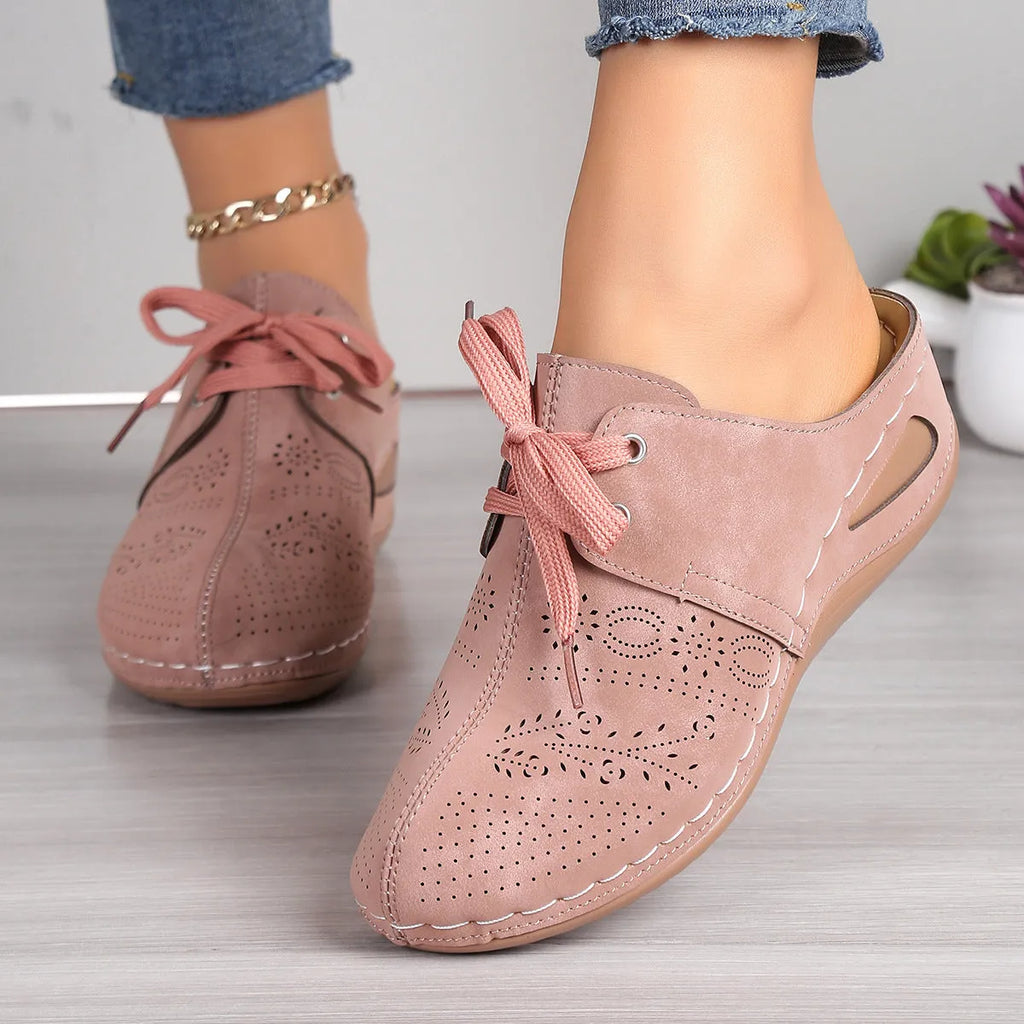Women's black lace-up wedge slippers with hollow-out design, suede upper, and rubber sole.