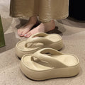 Women's thick-soled height increasing flip-flops in black with herringbone EVA upper