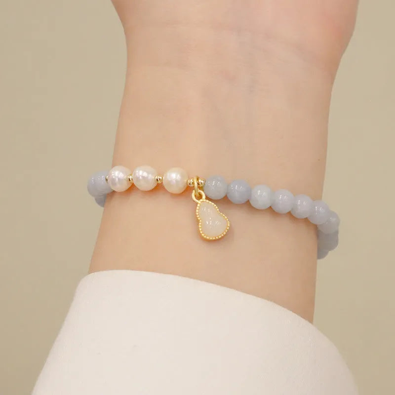Aquamarine crystal bracelet with gold-plated climbing cat charm for women