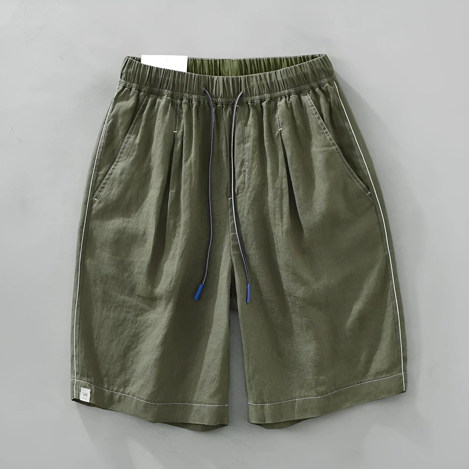 Men's straight-leg linen shorts in black or green with drooping style and drawstring mid-waist.