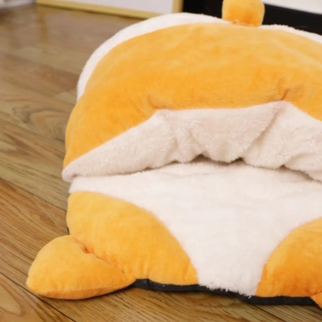 Orange semi-closed cat sleeping bag nest bed on a floor