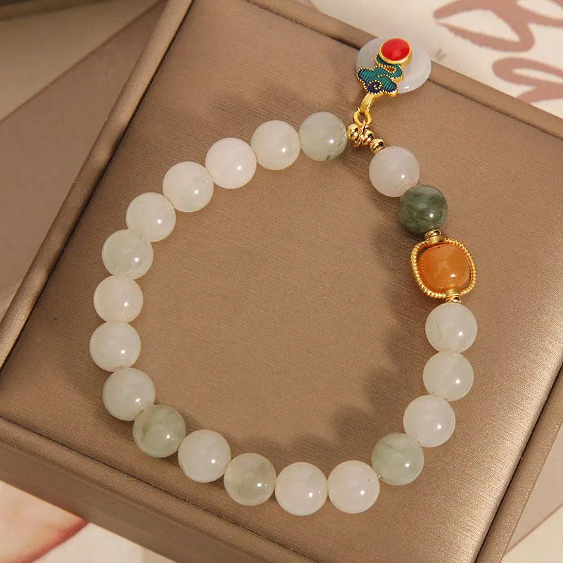 Women's ice jade crystal bracelet with pearl accents and a Xiangyun peace jade buckle.
