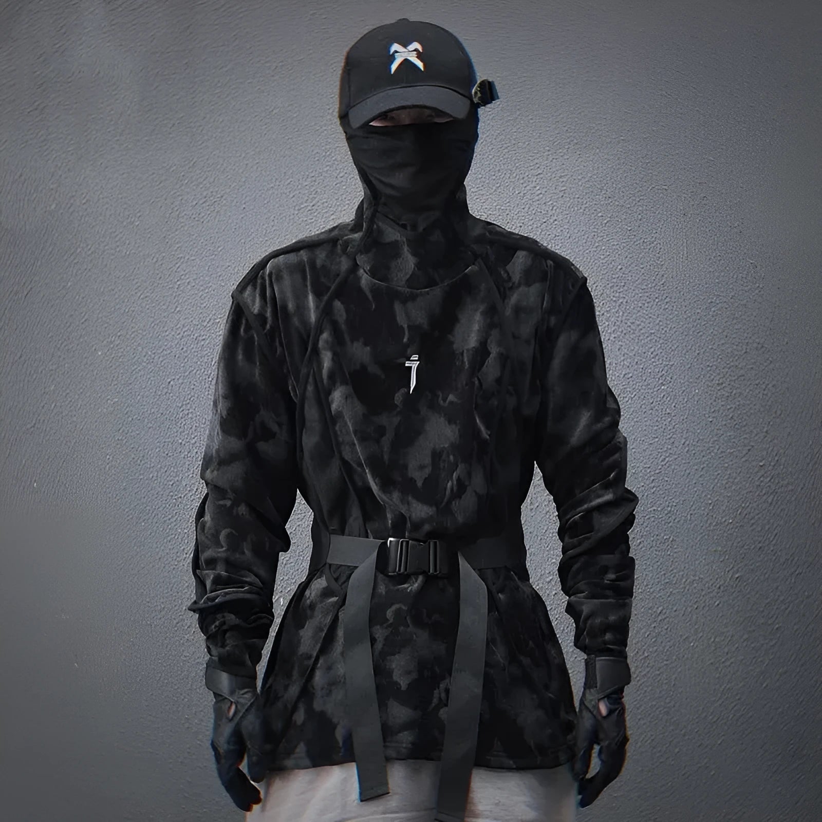 Man wearing a black tie dye print loose pullover sweater with drop-shoulder sleeves.