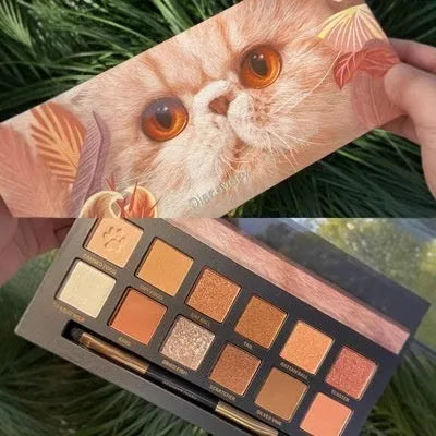 Open palette showing twelve pressed powder eyeshadow pans with animal-themed colour names.