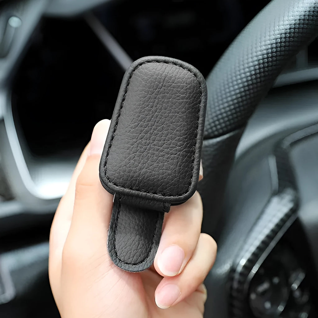 Car sunglasses clip holder made from PU leather in various colours, clipped to a sun visor.