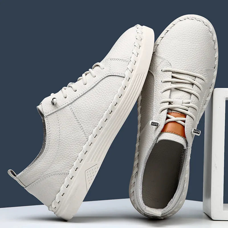 Men's beige and black cowhide leather sneakers with mesh lining and round toe.