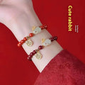 Purple Gold Sand cinnabar bracelet with jade hare charm, shown in 6mm and 8mm bead sizes.