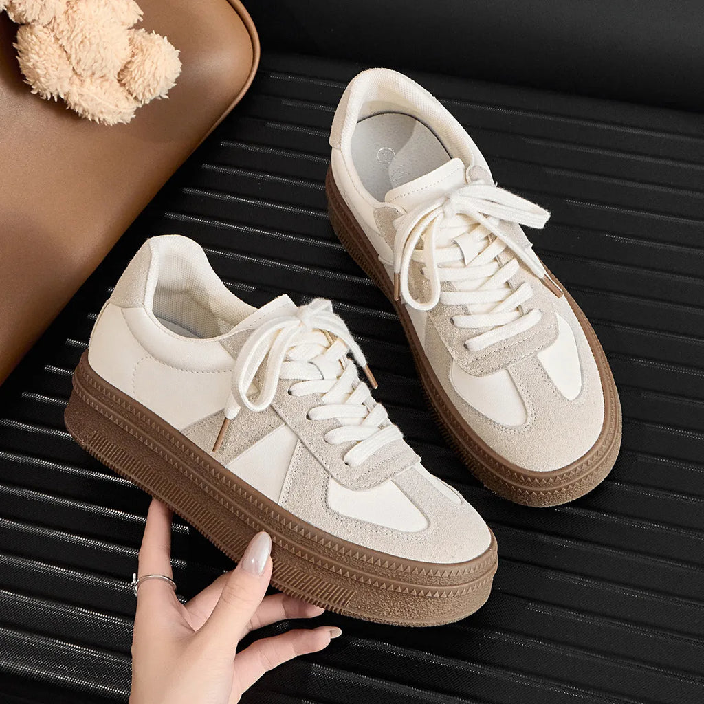 Retro sports board shoes with cross shoulder straps in milky white colour showing round toe and lace-up design