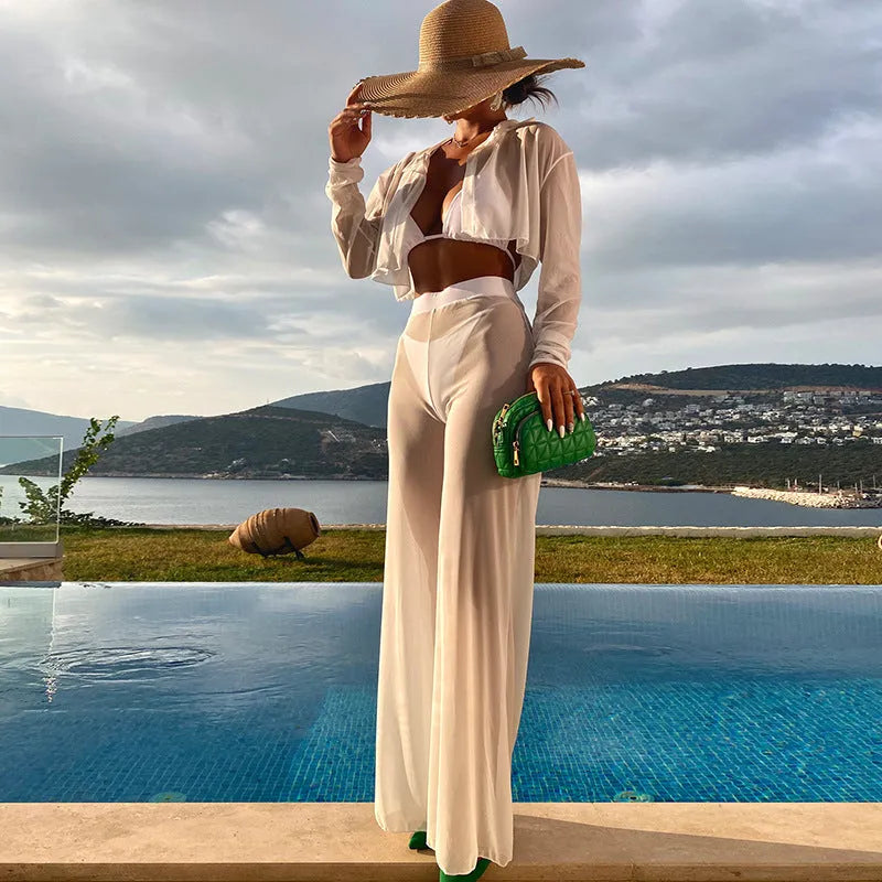 White four-piece women's swimsuit set with high-waist trousers and backless top