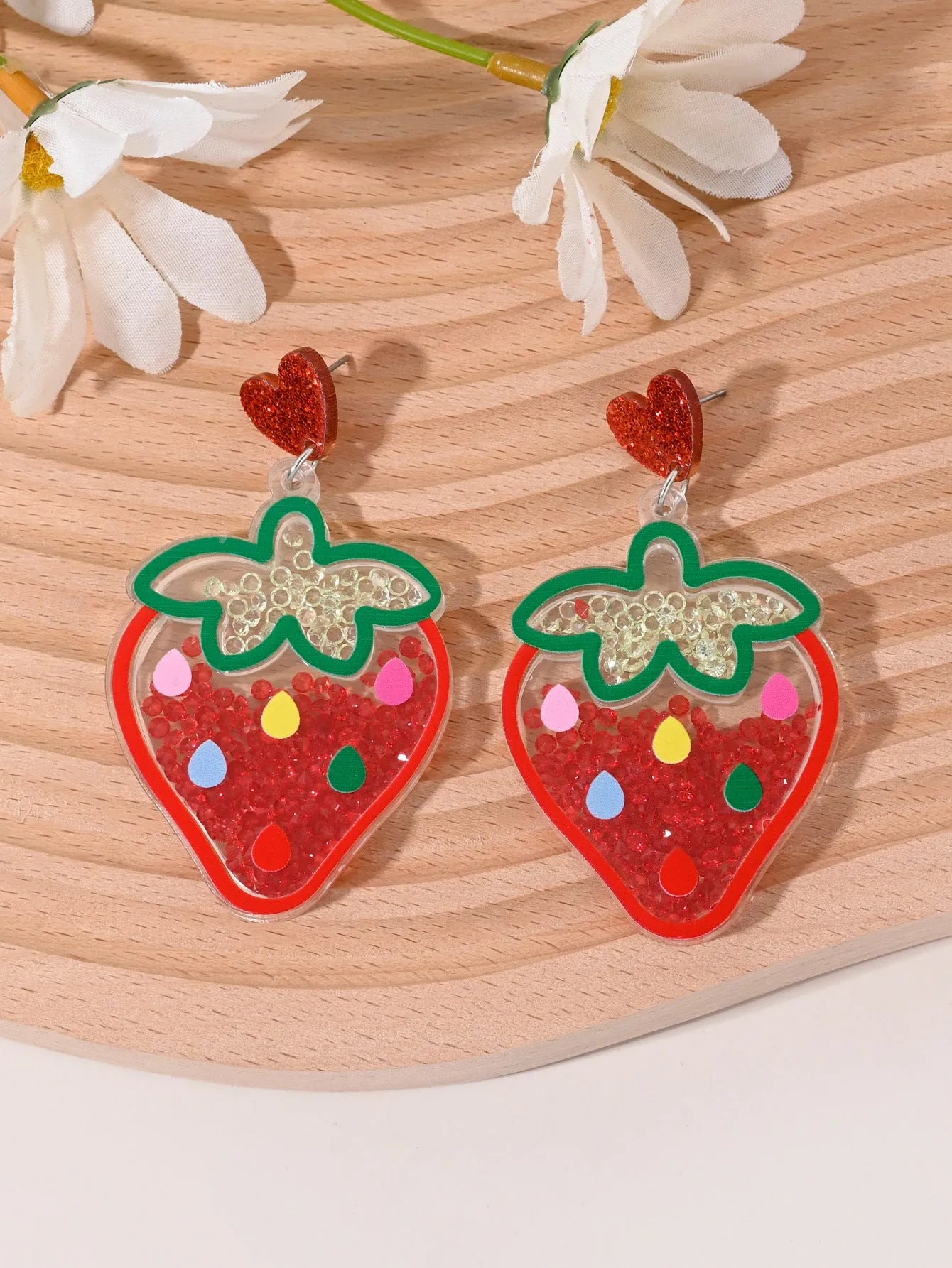 Colourful acrylic earrings with realistic fruit and dessert charms including cherry, strawberry, and ice cream.