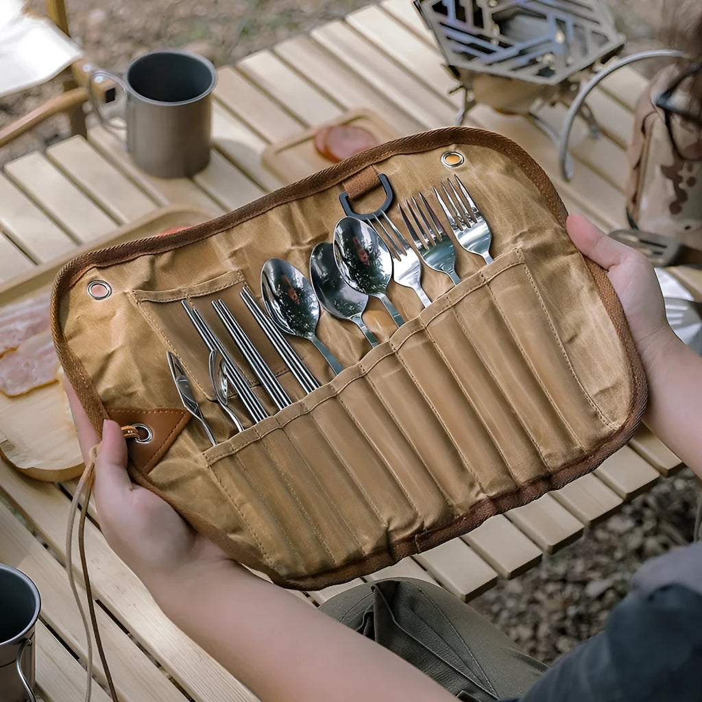 Waxed canvas tableware storage bag containing wooden handle cutlery set with chopsticks, knife, fork and spoons