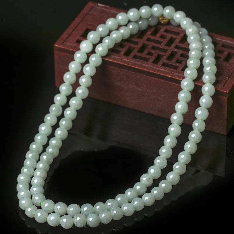 Women's adjustable jade bead necklace with round white green beads on a chain.