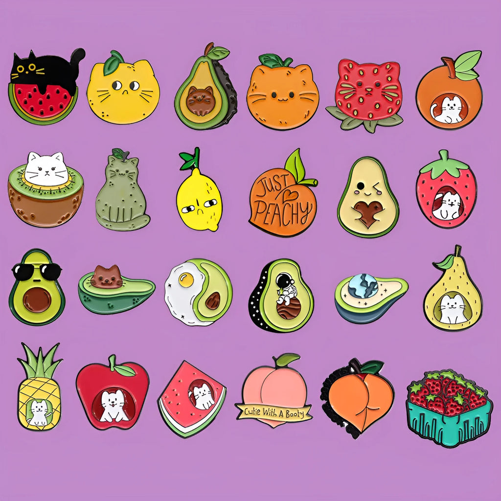 Colourful cartoon fruit and letter design on a silver-toned metal brooch pin.