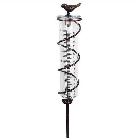 Cast iron garden rain gauge with decorative hummingbird design showing measurement scale