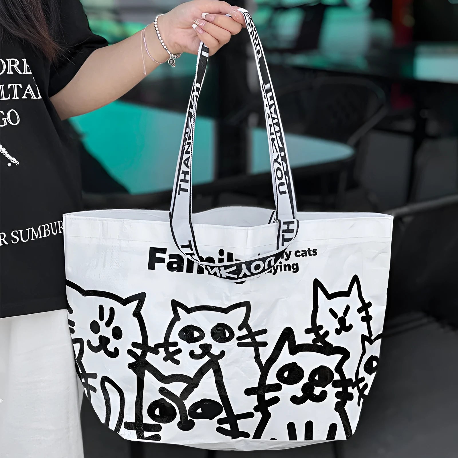 Blue waterproof PP woven handbag with colour printed design showing clothing and cosmetics storage
