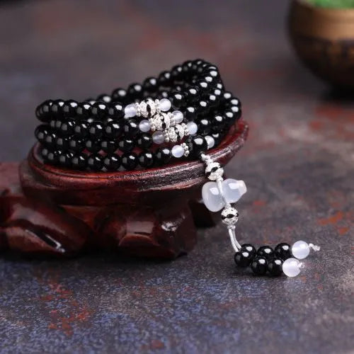 Black agate 108 bead unisex geometric bracelet with number elements.