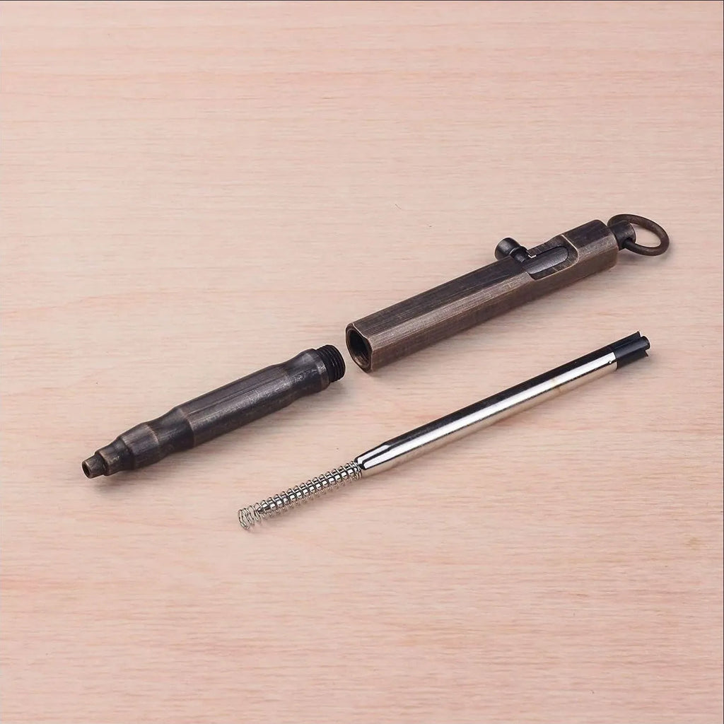 Brass tactical pen with hexagonal bolt pattern showing natural colour finish and precise machining details