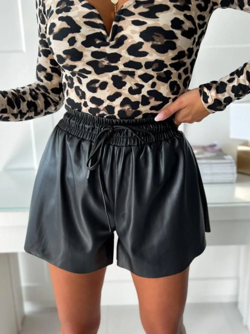 Women's black wide-leg shorts with drawstring lace-up waist detail and straight silhouette