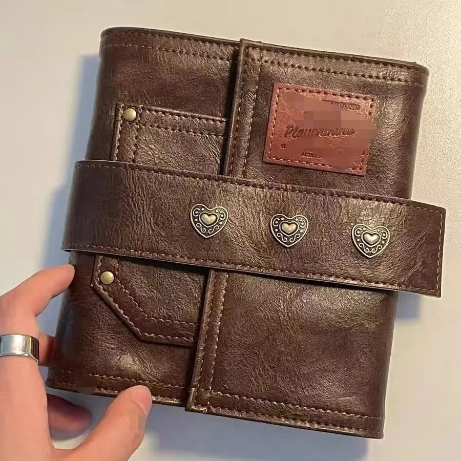 Brown retro buckle notebook with PU leather cover showing loose-leaf binder binding and A7 size format
