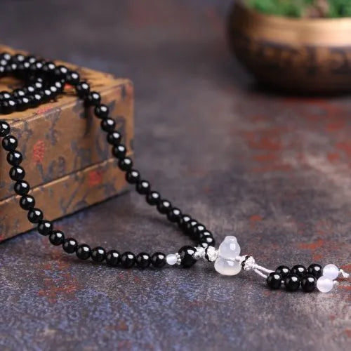 Black agate 108 bead unisex geometric bracelet with number elements.