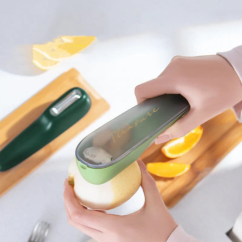 Dark green kitchen peeler with storage tube and stainless steel blade for vegetables