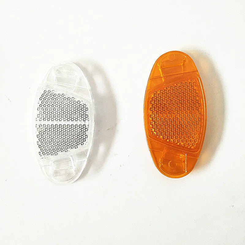 White and yellow plastic bicycle spoke reflector decorations showing front and rear placement on wheel spokes